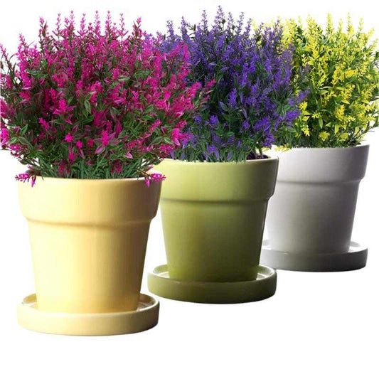 Artificial flowers in vibrant purple, fuchsia, and yellow, displayed in pastel pots, ideal for DIY home decor.