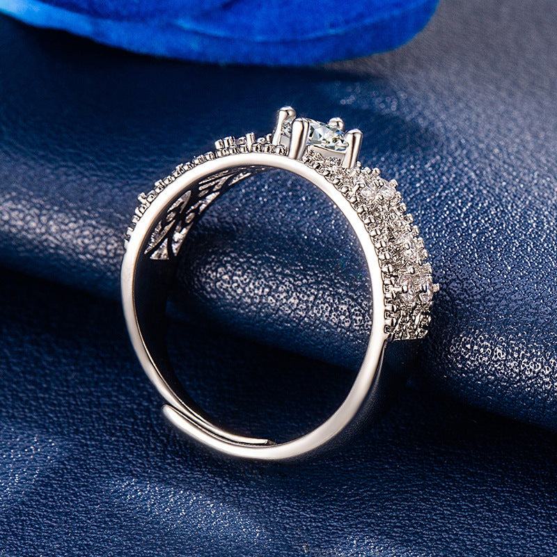 Adjustable copper color moissanite ring with U-shaped design and diamond lattice detailing on navy blue background