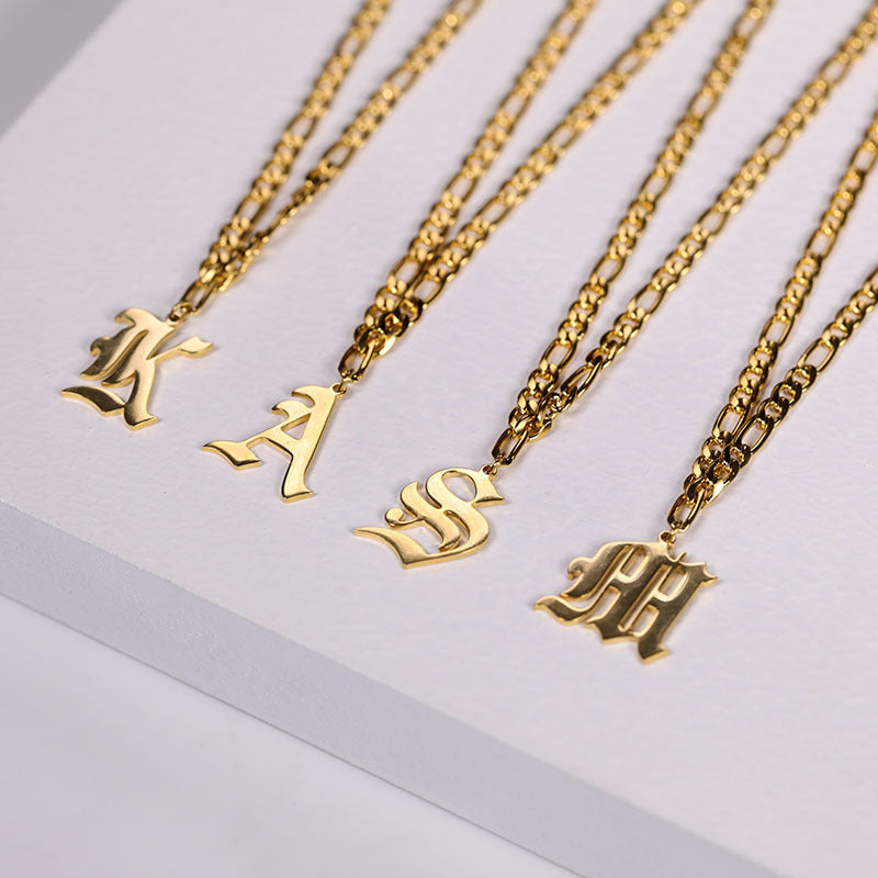 Gold stainless steel English nameplate necklaces with Cuban chains in letters K, A, S, and M