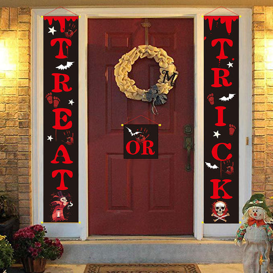Halloween outdoor banner decoration with TREAT and TRICK couplets in red and black, featuring bats, footprints, and Halloween-themed graphics on a front door setup