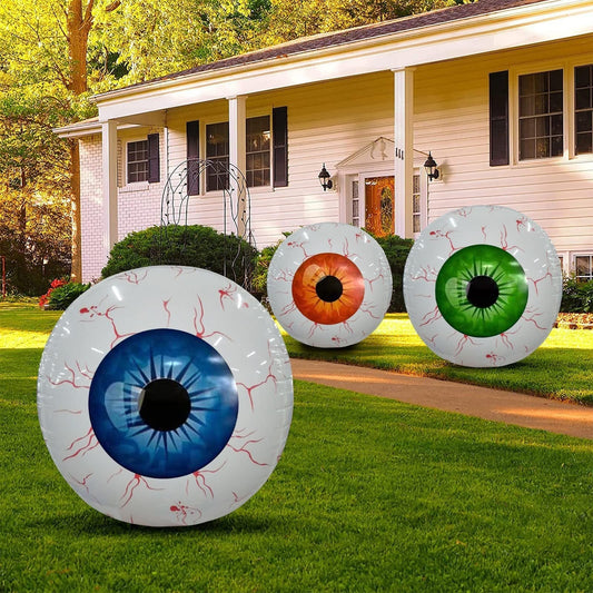 Inflatable Halloween eyeball balloons in blue, orange, and green with bloodshot design displayed as outdoor Halloween decorations.