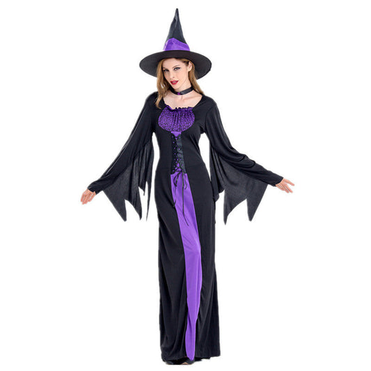 Woman wearing black and purple Halloween witch costume with pointed hat and long flowing sleeves