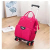 Wheeled travel bag with pink Oxford material and telescopic handle.