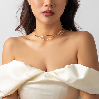 Female model wearing a gold simple clavicle chain open line geometric neck ring with off-shoulder white dress