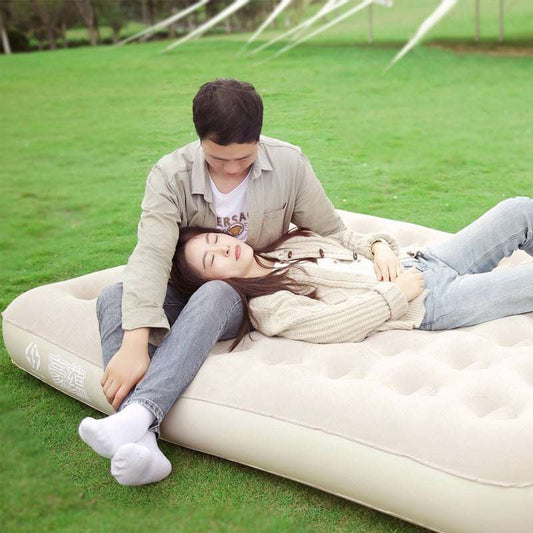 Thickened flocking bed with two people relaxing outdoors.