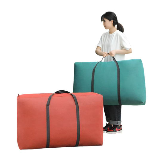 Woman loading blue and green moving packing bags into car.