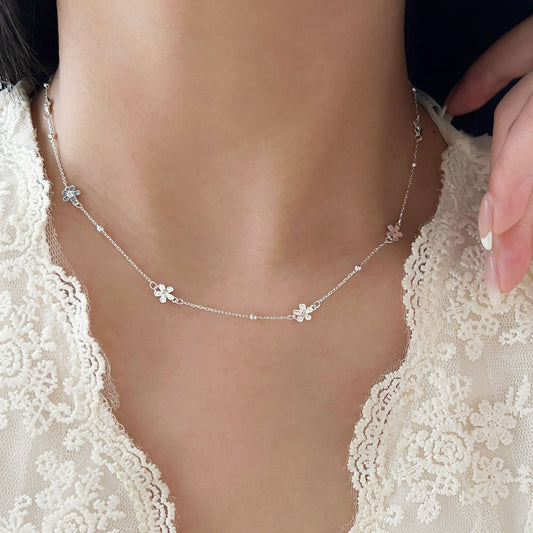 Changheng S925 sterling silver delicate small flower necklace on woman wearing lace top