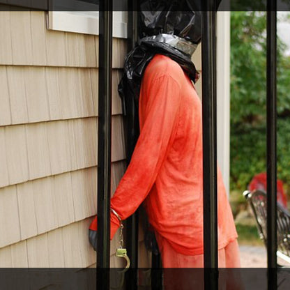 Realistic prisoner corpse Halloween decoration in the front yard 