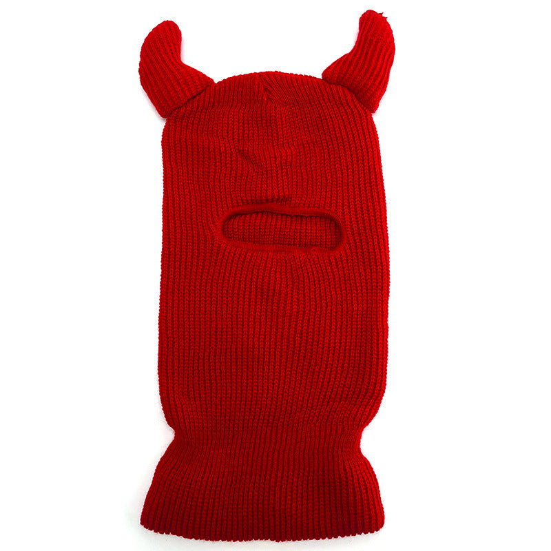 Red knitted balaclava with animal ears on a white background