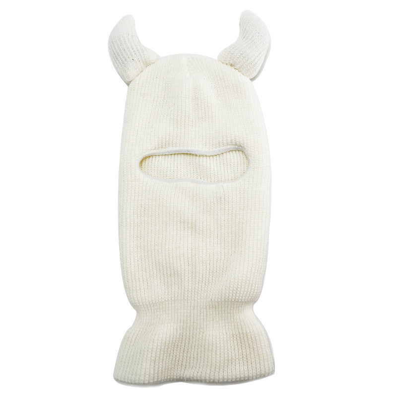 White knit balaclava with animal horn designs on a white background