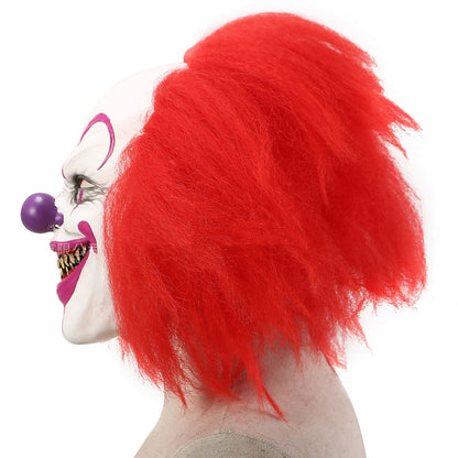 Side angled view of a clown mask with red hair and a purple ball on a white background