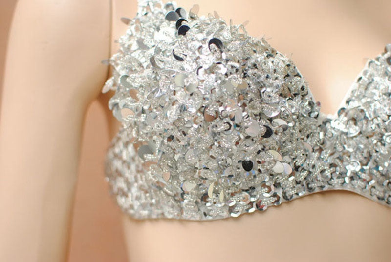 Silver sequin top worn by a person with a blurred background